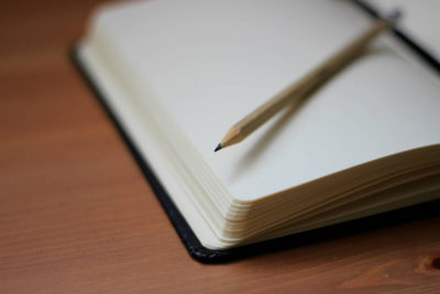 blank notebook with pencil